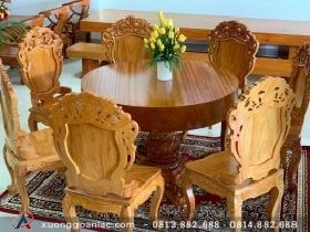 Bộ bàn ăn tròn nguyên khối gỗ gõ đỏ 7 ghế đục hoa lá tây (Anh Sơn, Hà Nội)