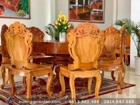 Bộ bàn ăn tròn nguyên khối gỗ gõ đỏ 7 ghế đục hoa lá tây (Anh Sơn, Hà Nội) 9 Chân trụ bàn à một khối trụ tròn được điêu khắc dạng lục bình hút sinh khí